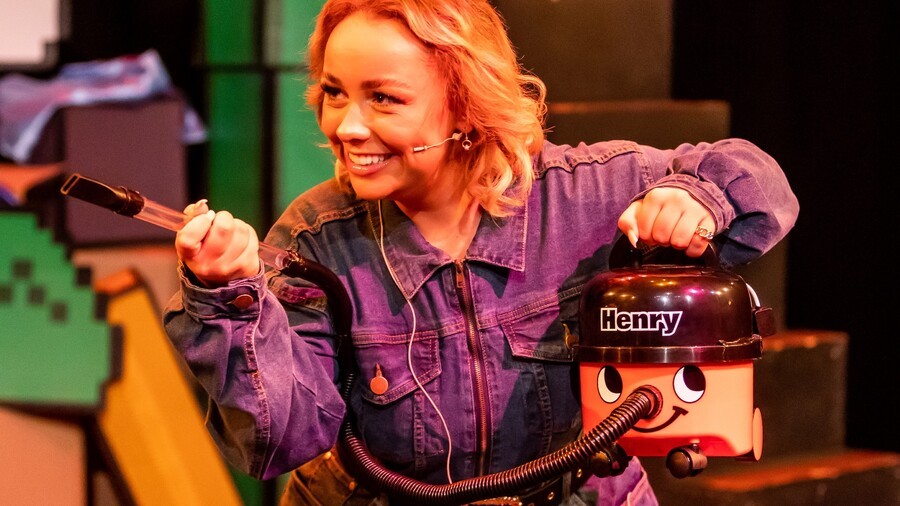 Luigi with his — er, HER trusty vacuum