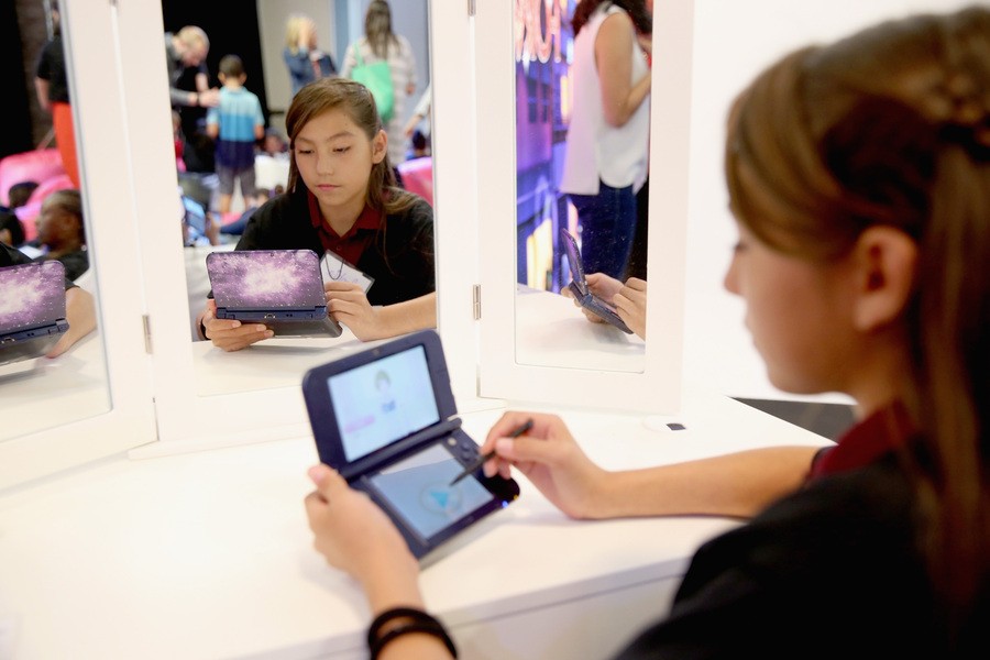 In this photo provided by Nintendo of America, Sophia S. from Compton, California, plays the Style Savvy: Fashion Forward game on the New Galaxy Style New Nintendo 3DS XL system, available now for a suggested retail price of $199.99, at Big Door Studios in El Segundo, California, on Aug. 30, 2016. In Style Savvy: Fashion Forward, players can manage their own boutique, design clothes, style hair, master the art of makeup and become the next top model.