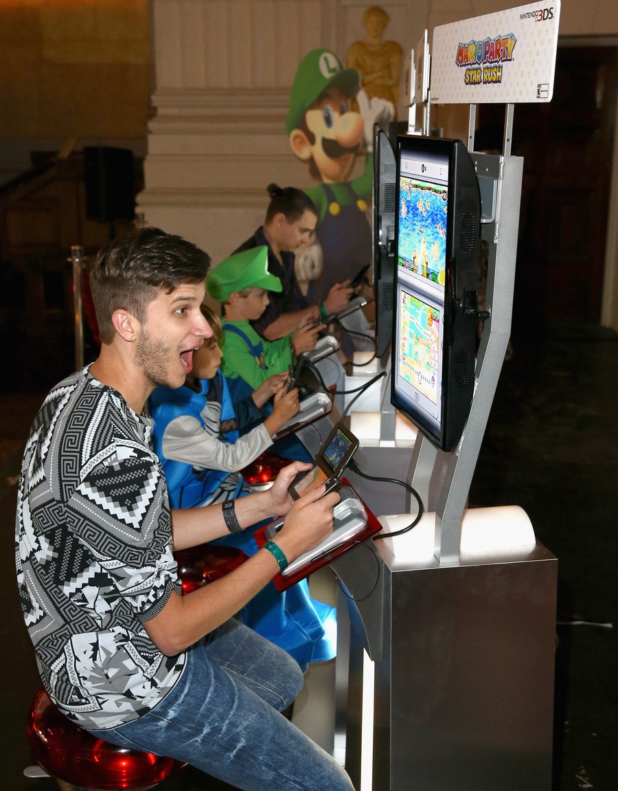 In this photo provided by Nintendo of America, Zach D. of YouTube channel GhostRobo, plays a friendly round of competition in the Mario Party Star Rush game with guests at Starlight Children’s Foundation’s “Dream Halloween” event on Oct. 22 in Los Angeles.