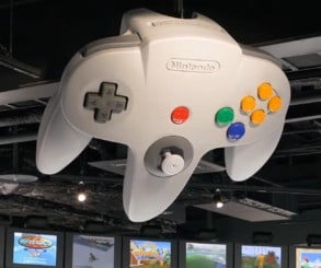 Giant Nintendo controllers and systems hang from the roof in this area