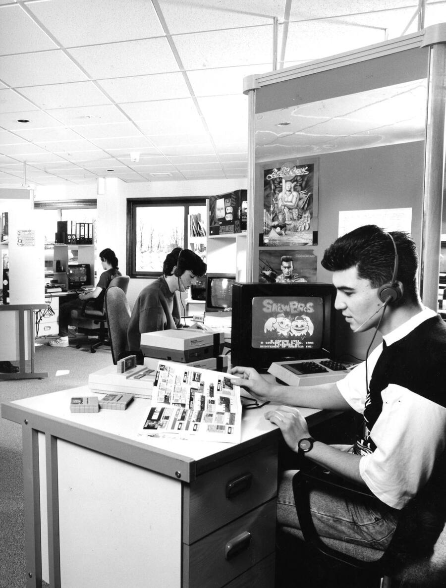 Daryl Jones takes a call whilst obscure NES game Snow Bros tries to lure him in. Mark Todd and Mike Barnes toil behind.