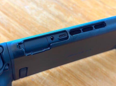 A close-up of the bevelled and die-cut cart USB-C, vent, power button, and volume control slots