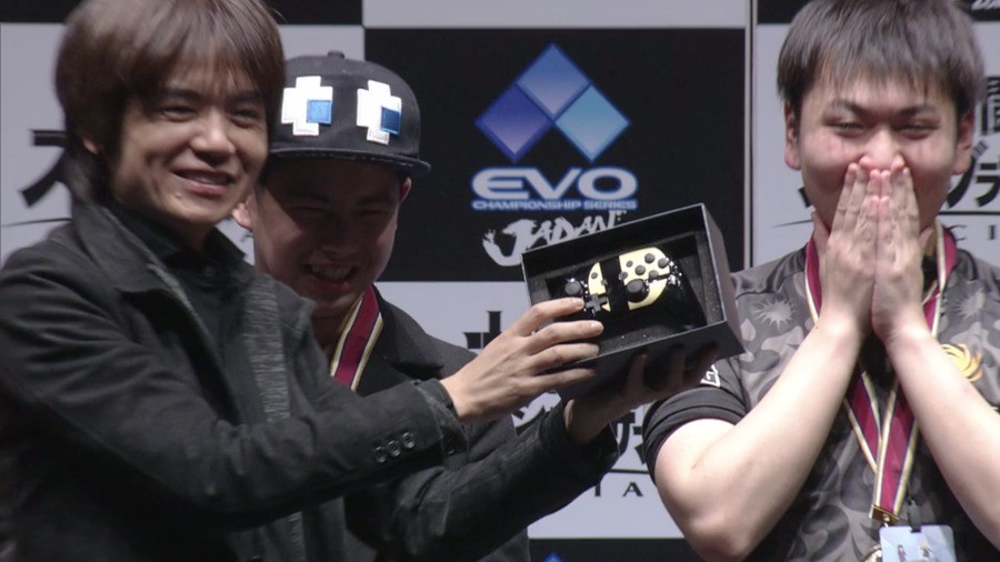 Masahiro Sakurai hands over the top prize