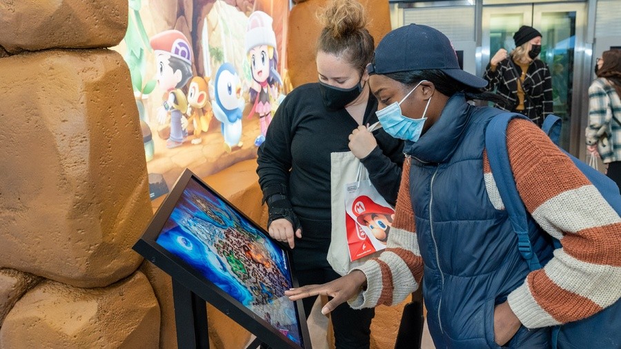 Fans explore the map of Pokémon Brilliant Diamond and Pokémon Shining Pearl’s Sinnoh region in the Nintendo NY store.